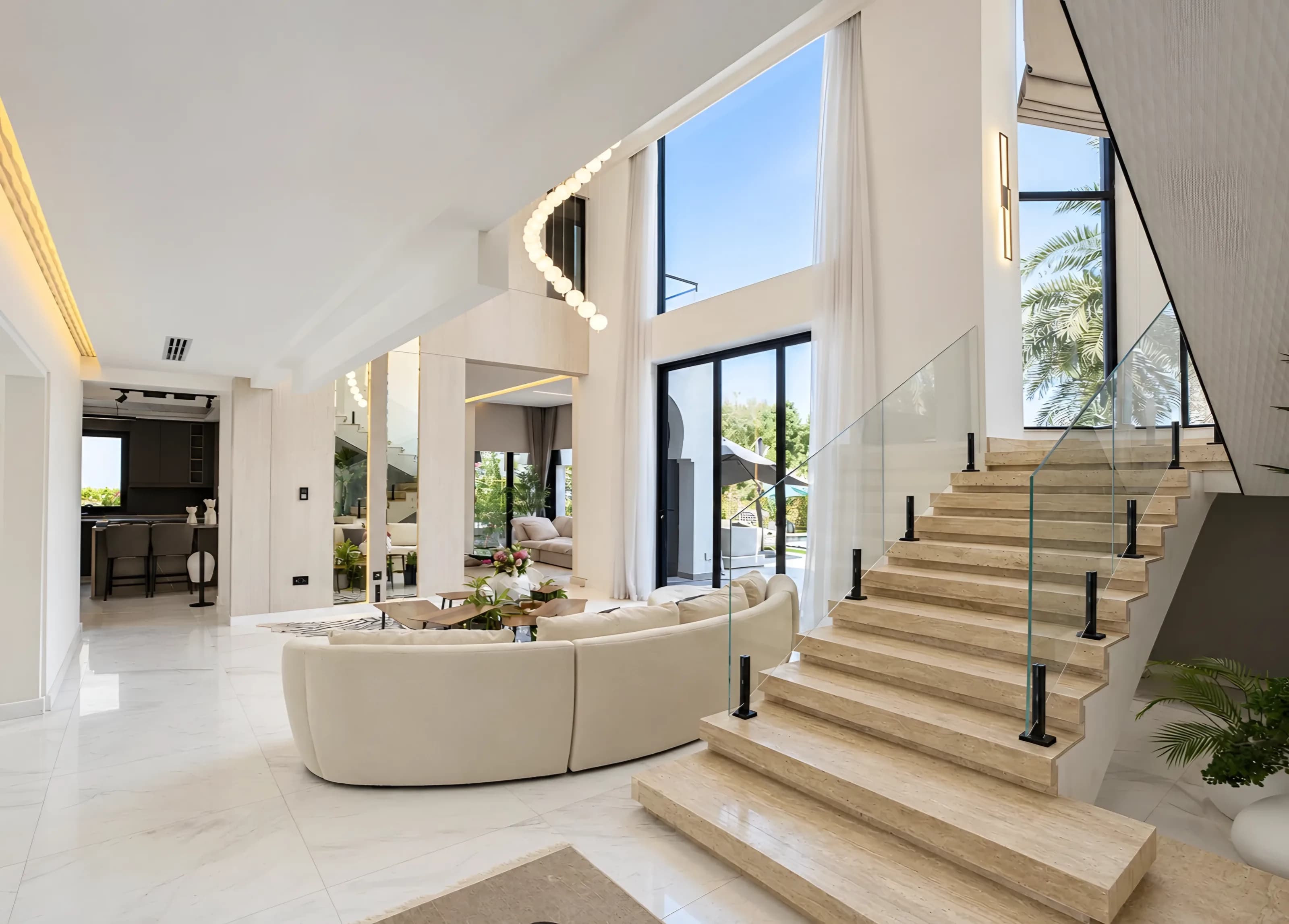 Double-height living room and staircase in a Jumeirah Islands villa